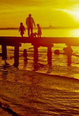 Family on the pier at sunset